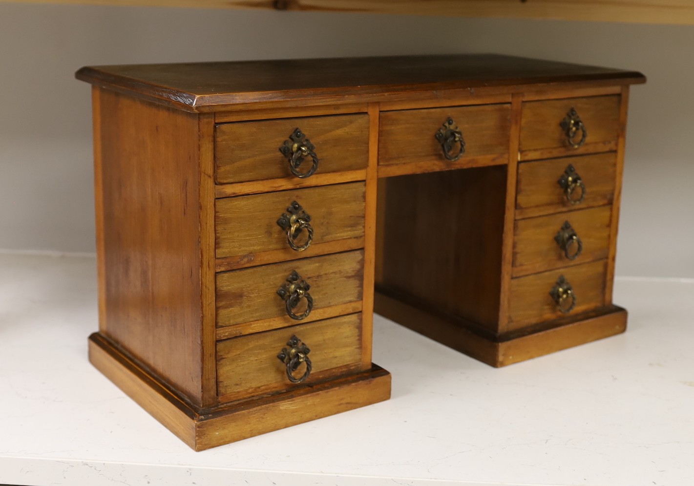 A late 19th century walnut model of a pedestal desk. W- 48cm, H - 27cm, D - 22cm